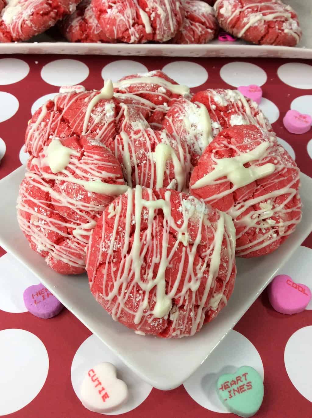 A deliciously and easy Valentine Cake Mix Crinkle Cookie recipe made with a white cake mix and topped with white chocolate drizzle. 