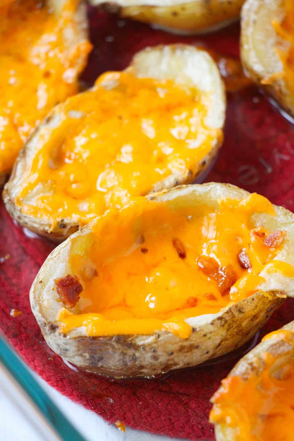 Homemade crispy, cheesy, baked potato skins are the perfect loaded appetizer for any get together that your family and friends will love topped with cheese, bacon, and sour cream.