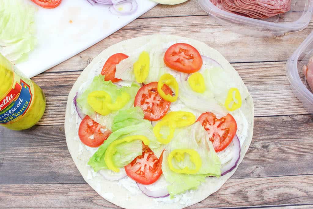 These Italian roll-ups aka tortilla roll-ups, ham pinwheels, or appetizer roll-ups, they are so easy to make and make a great lunch or appetizer. Use your favorite ham, salami, turkey, pepperoni and cheeses to make these your own. 