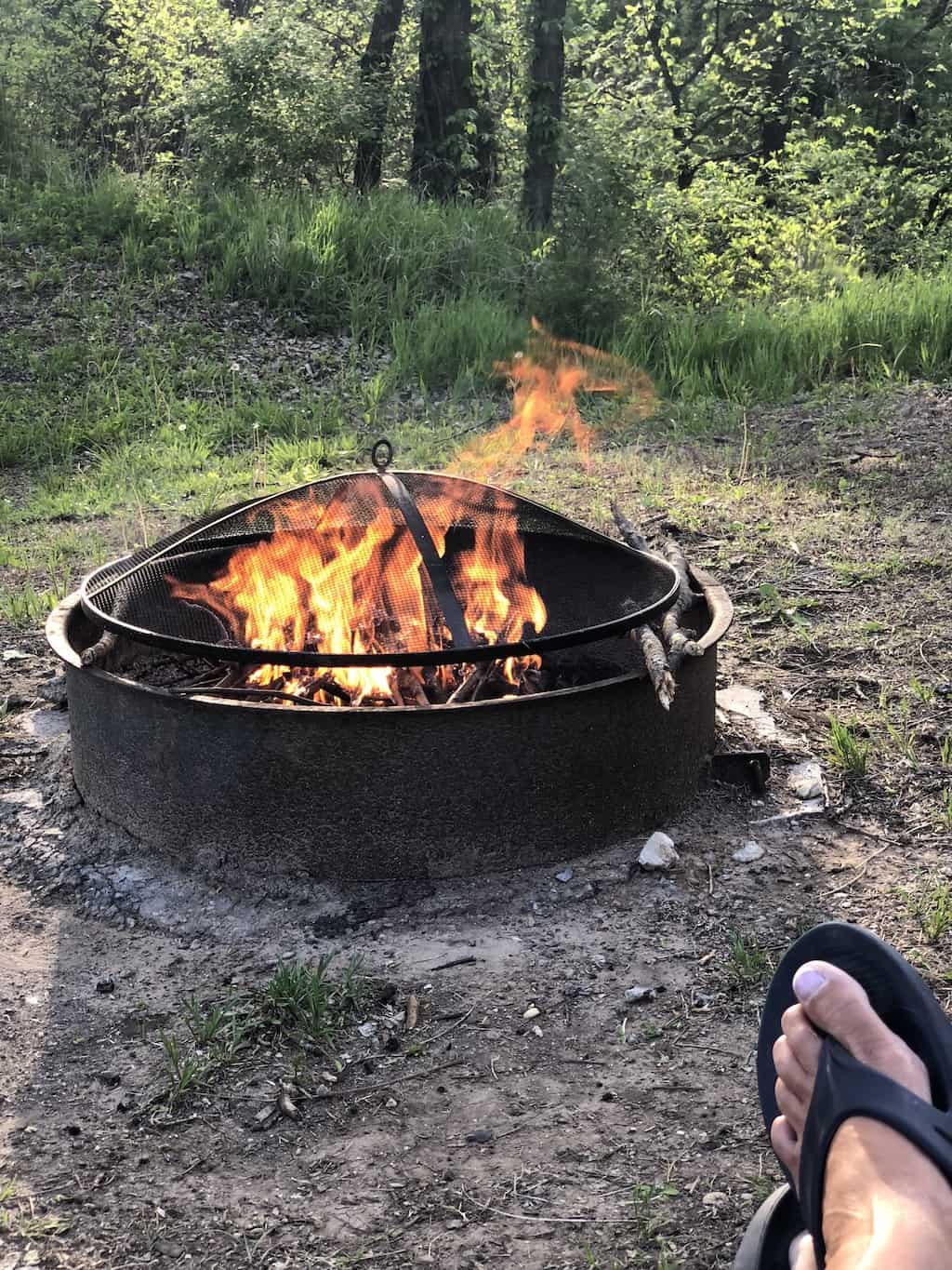 Check out our 6 ways to save money on campsite rentals, so you can sleep under the stars for less. Enjoying an evening by the campfire. 