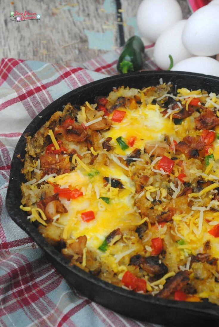 A perfect cast iron skillet southwest breakfast casserole campfire meal with all your favorites, eggs, hash browns, bacon, peppers, jalapenos, and cheese. 