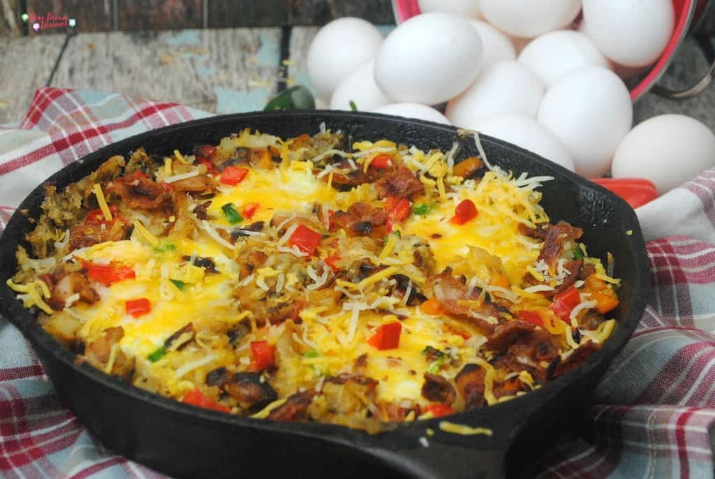 A perfect cast iron skillet southwest breakfast casserole campfire meal with all your favorites, eggs, hash browns, bacon, peppers, jalapenos, and cheese. 
