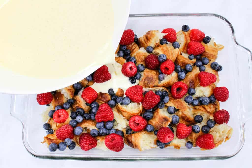 Made with fresh raspberries and blueberries, the Berry Croissant Breakfast Casserole Recipe can be used as a dessert and even makes a great breakfast on Christmas morning. 