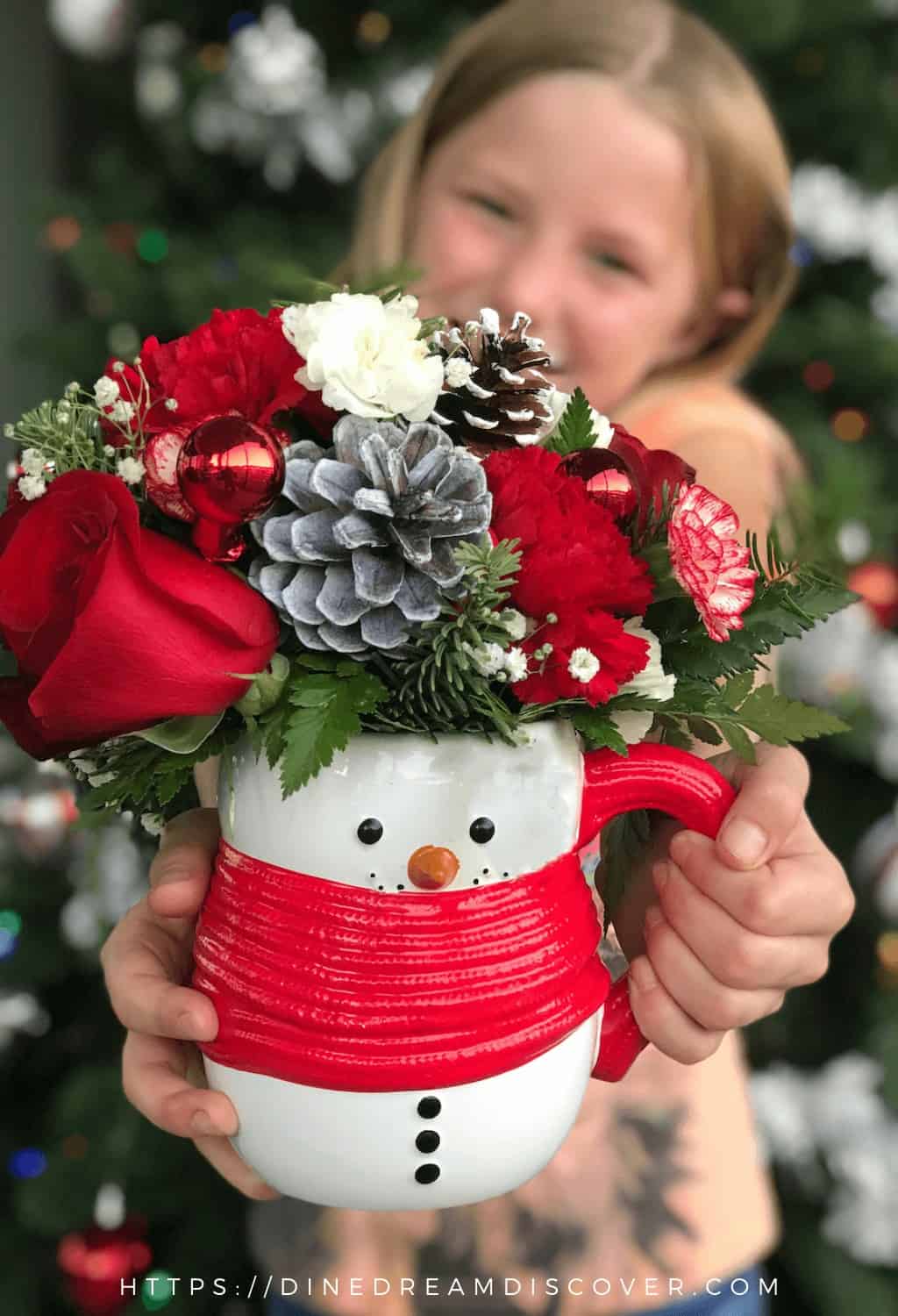 girl holding snowman mug bouquet